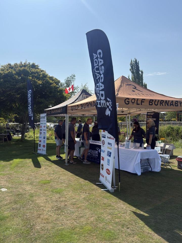Golfers stopped at the Cascade Aqua-Tech tent at the 2026 BC golf tournament